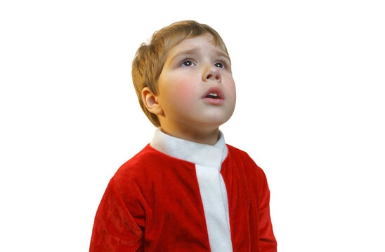 A boy in a Santa Claus costume looks away