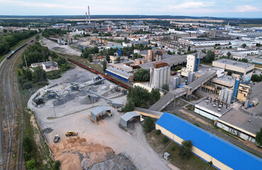 Obraz premium Cement plant and ready mix concrete. Plant for the production of cement and dry mortar for the construction industry. Crushing the stones for the cement production, Aerial View. Industrial solutions.