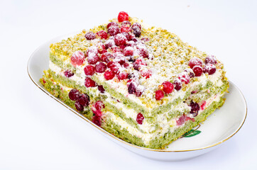 Piece of sweet sponge cake with cream and red cranberries. Studio Photo.