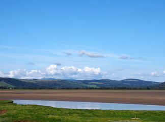 view of the village of arnside from the bank of the river kent with surrounding countryside