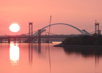 Fototapeta na wymiar Pink sunrise at Iowa bridge construction site