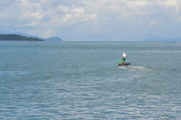 Sorong, West Papua, Indonesia, September 16th 2021. Solitary fisherman is fishing at the sea.