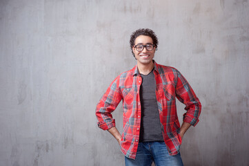 Obraz premium young man in casual shirt holding hands in pockets
