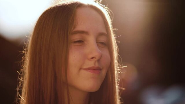 Beautiful young woman with clean and pefect Skin relaxing in the park. Portrait of cheerful university student. Happy girl in the park