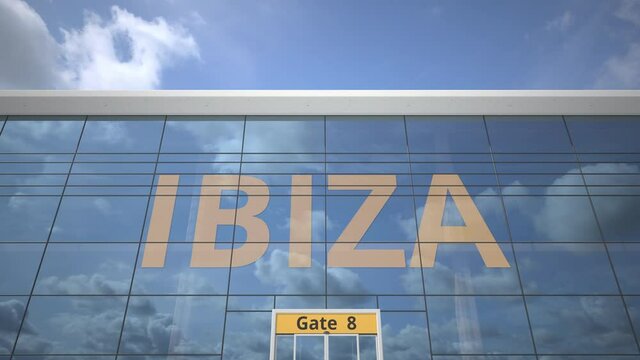 Plane reflects in the airport terminal with IBIZA city name