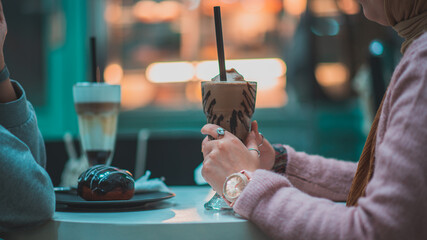 Woman holding a cup of ice coffee