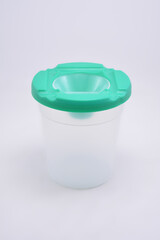 Coloring paint transparent cup use to put water and art brush