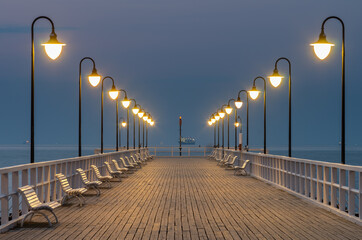 Baltic sea coast, night view of pier at Gdynia Orlowa sea resort, Poland.