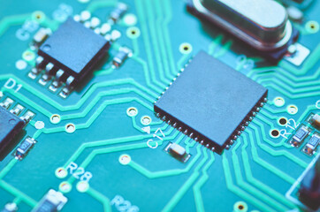 High-tech electronic board with processor and electronic components close-up, soft focus