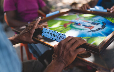 Playing dominoes. Person hands. Street game Dominican Republic Caribbean - obrazy, fototapety, plakaty