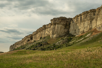 Panorama of the steppe landscape. View from the mountain to the surrounding area. Fields, roads, villages, mountains from a bird's eye view. Day. Summer