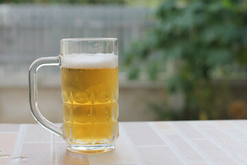 cold beer in glass with blurred background