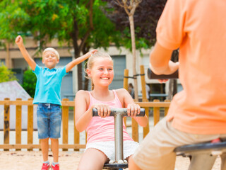 Fototapeta na wymiar Children are teetering on the swing on the playground.
