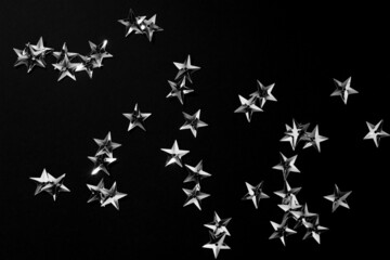 Silver stars on black background. Abstract Background. Metallic star pattern for banner or holiday cards