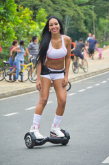 Latina sports woman with electric skateboard on the street © Rafael