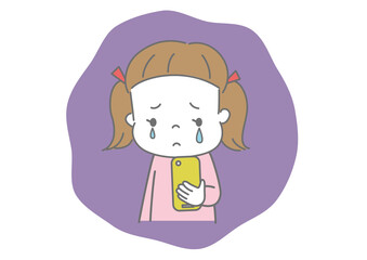 スマートフォンを見て泣いている女の子
