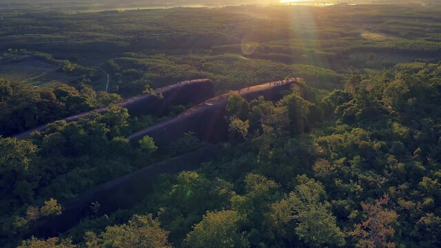Aerial view dolly in and tilt down of Exotic landscape and wonderful during morning sunrise over the Three Whale Rocks (Hin Sam Wan)  famous tourist attraction at Bueng Kan province amazing Thailand 