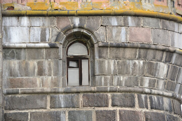 Embrasure window in medevial castle wall. Recessed frame window in old stone wall.