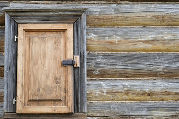 Wooden gate locked with a padlock. 
