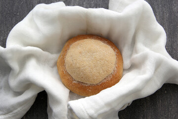 Freshly made Ojo de Pancha or Ox bread from Mexican cuisine in a basket, or napkin accompanied by coffee
