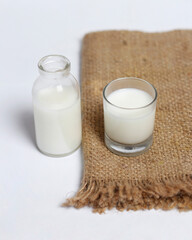 White milk drink served with bread is good for breakfast in the morning. This fresh cow's milk in addition to its sweet taste also contains many nutrients. warm milk in a glass cup.