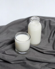 White milk drink served with bread is good for breakfast in the morning. This fresh cow's milk in addition to its sweet taste also contains many nutrients. warm milk in a glass cup.