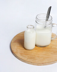 White milk drink served with bread is good for breakfast in the morning. This fresh cow's milk in addition to its sweet taste also contains many nutrients. warm milk in a glass cup.