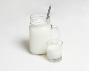 White milk drink served with bread is good for breakfast in the morning. This fresh cow's milk in addition to its sweet taste also contains many nutrients. warm milk in a glass cup.