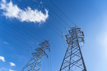 High-voltage line tower blue sky and white clouds