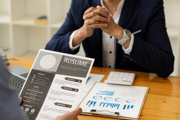 Man sends his boss a resume to apply for a job at a company. A fresh graduate holding a job application with a keyboard, pen, and notebook to apply for a job. and the boss is reviewing the resume