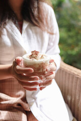 Woman hands  holding cup of coffee&nbsp;with latte art. holding cup of tea or coffee in the morning