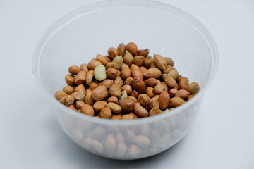 Nuts in container isolated on white background