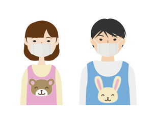 Fototapeta premium マスクを付けたエプロン姿の保育士たち（上半身） 
