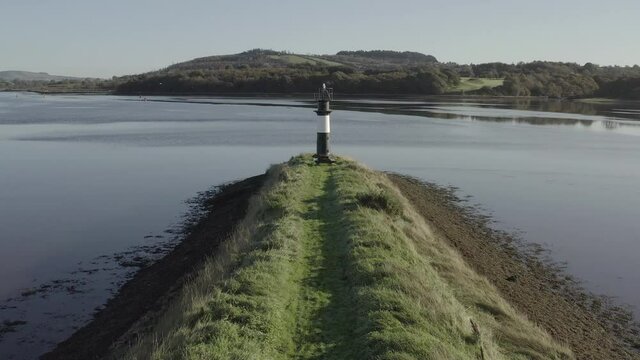 Lighthouse on spit guides river traffic between Kings Channel and Suir