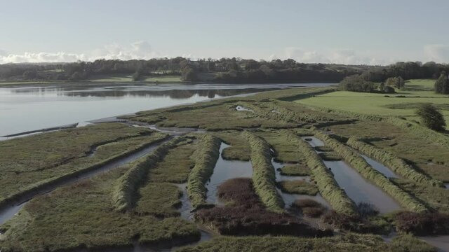 Aerial flight over flooded man-made mounds on river at Waterford, IRL