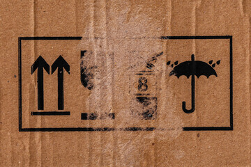 Signs on a torn cardboard box. International Packing Symbols