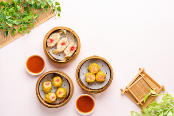 Top View of Assorted Chinese Dimsum in bamboo basket. Dimsum is a large range of small dishes that Cantonese people traditionally enjoy in restaurants for breakfast and lunch.