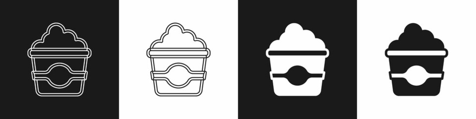 Set Popcorn in cardboard box icon isolated on black and white background. Popcorn bucket box. Vector