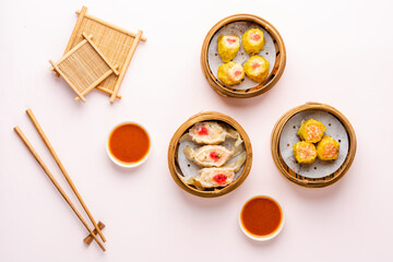 Top View of Assorted Chinese Dimsum in bamboo basket. Dimsum is a large range of small dishes that...