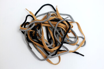 Stack of shoelaces on a white background, abstract - obrazy, fototapety, plakaty
