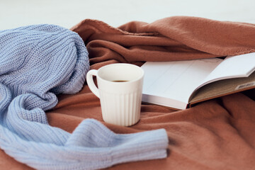 a blanket near the window a cup of coffee book Comfort rest