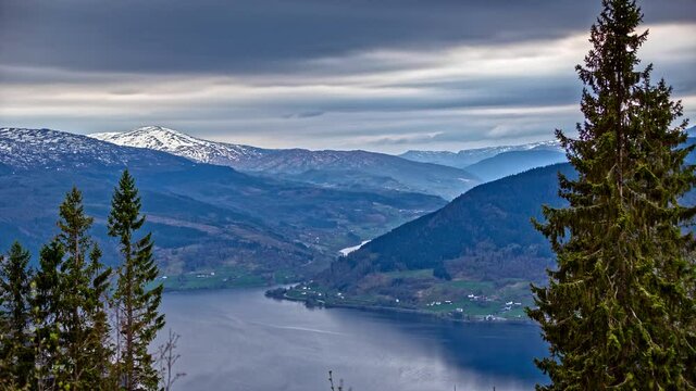 Timelapse of clouds at Ardalsfjord, near Ovre Ardal, Vestland, Norway. Mountain lake and evergreen coniferous forest. Shot in 5k.