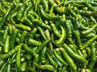 lots of green chilies. Close up top view of lots of Indian green chili peppers.