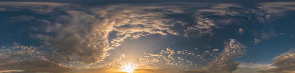 Golden sunset sky pano with Cumulus clouds. Seamless hdr panorama in spherical equirectangular format. Complete zenith for 3D visualization, game and sky replacement for aerial drone 360 panoramas.