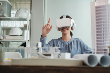 Happy smile Architect or Engineer female wearing VR headset in office. Technology futuristic virtual reality design.