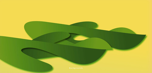 Green abstract shape isolated on a yellow background, looks like a plant in the afternoon.