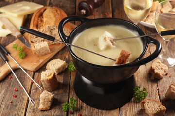 fondue cheese with bread and glasses of wine