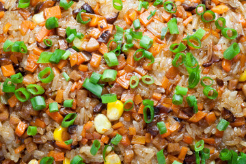 Cantonese fried glutinous rice with mushroom, corn, carrots and sausage. Chinese Food.