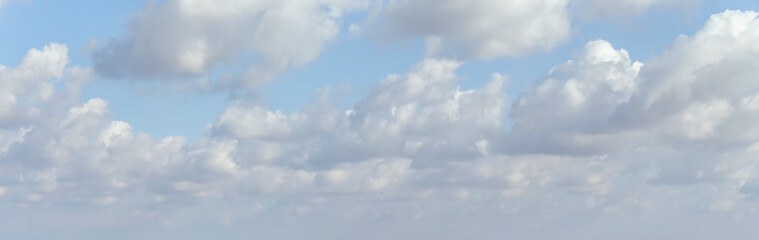 Cumulus fluffy clouds in sunny day, banner