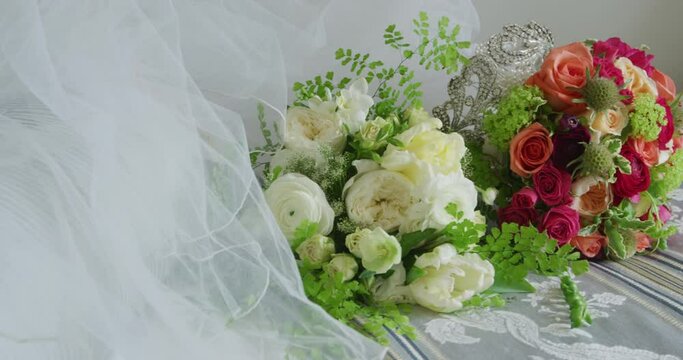 Wedding Bouquet and Veil accessories on White Cushion